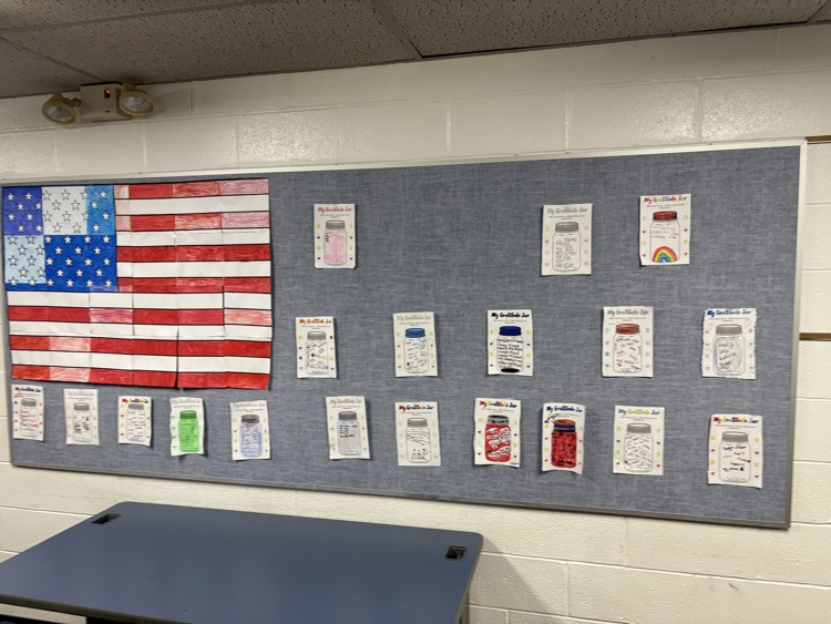 American Flag and pictures of gratitude jars on a bulletin board
