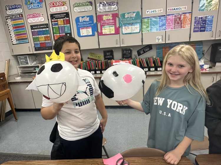 students holding balloons