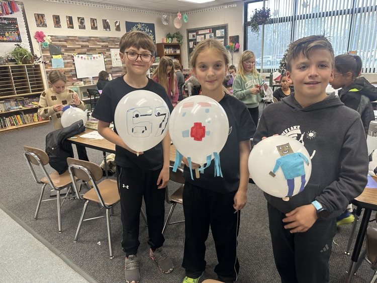 students holding balloons