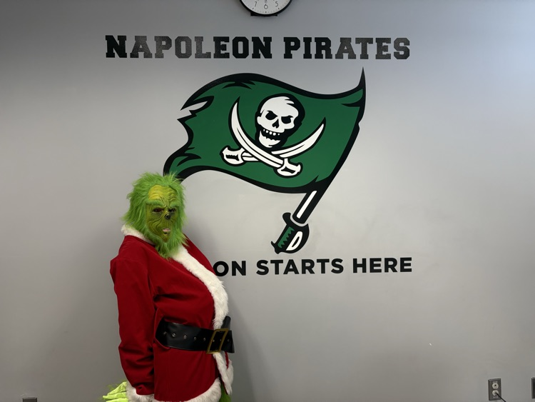 grinch standing in front of Napoleon Pirates flag
