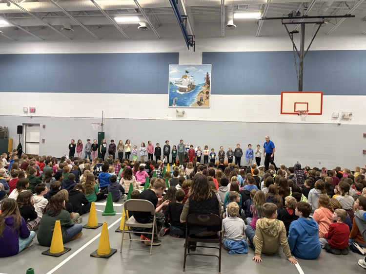 students sitting on the floor watching basketball tricks