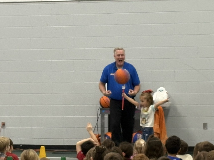 man helping balance basketball