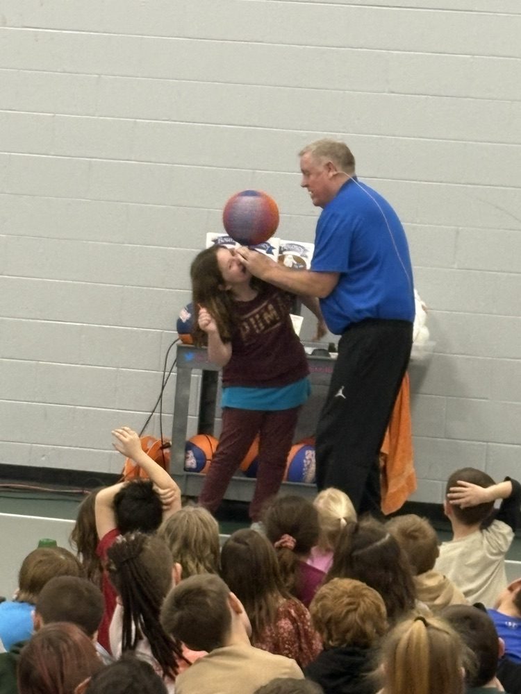 man helping girl balance basketball
