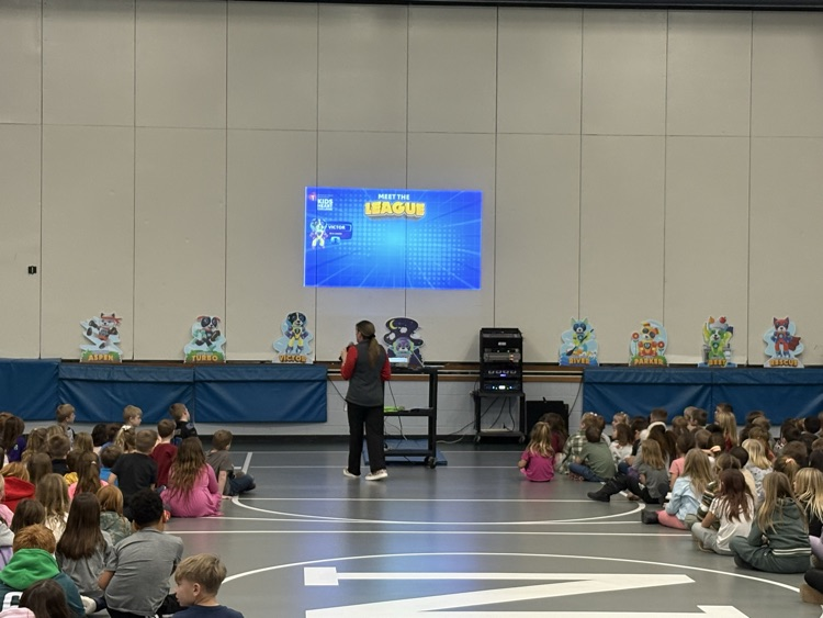 student speaking in front of students in front of screen