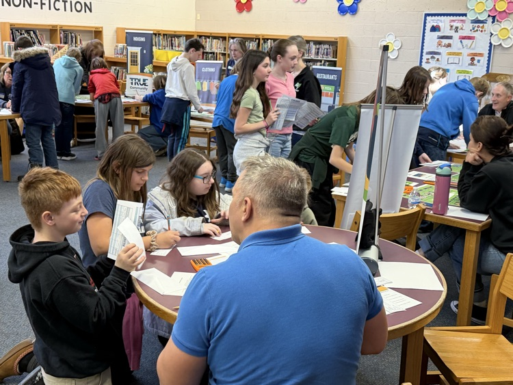 man helping students at reality fair