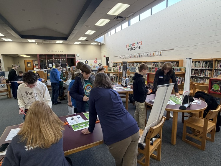 students in library participating in reality fair