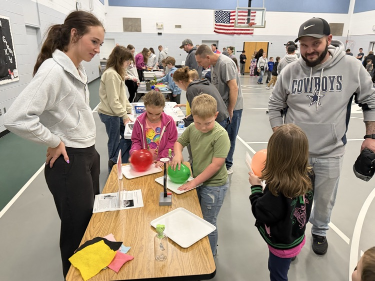 students watching a demonstration at a table