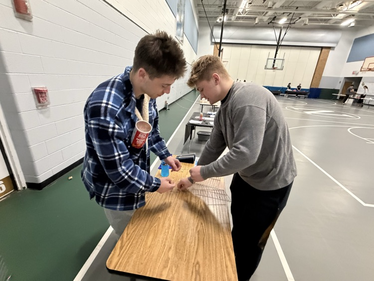 two students working on an activity at a table