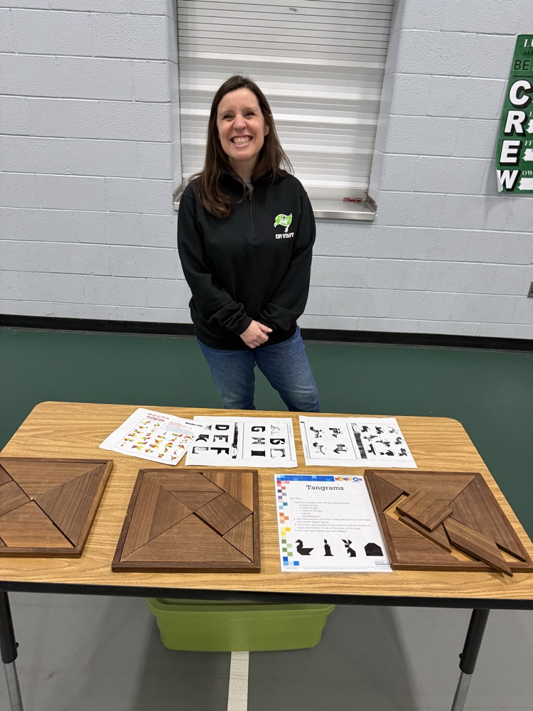 teacher standing behind a table of activities 