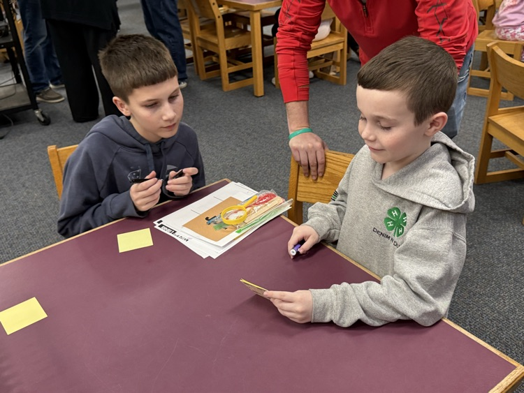 two boys sitting at a table 