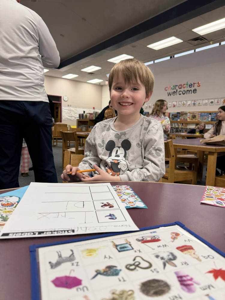 student working with letter chart