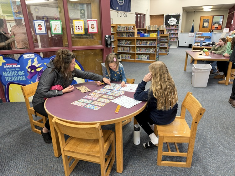 student and parent working at table 