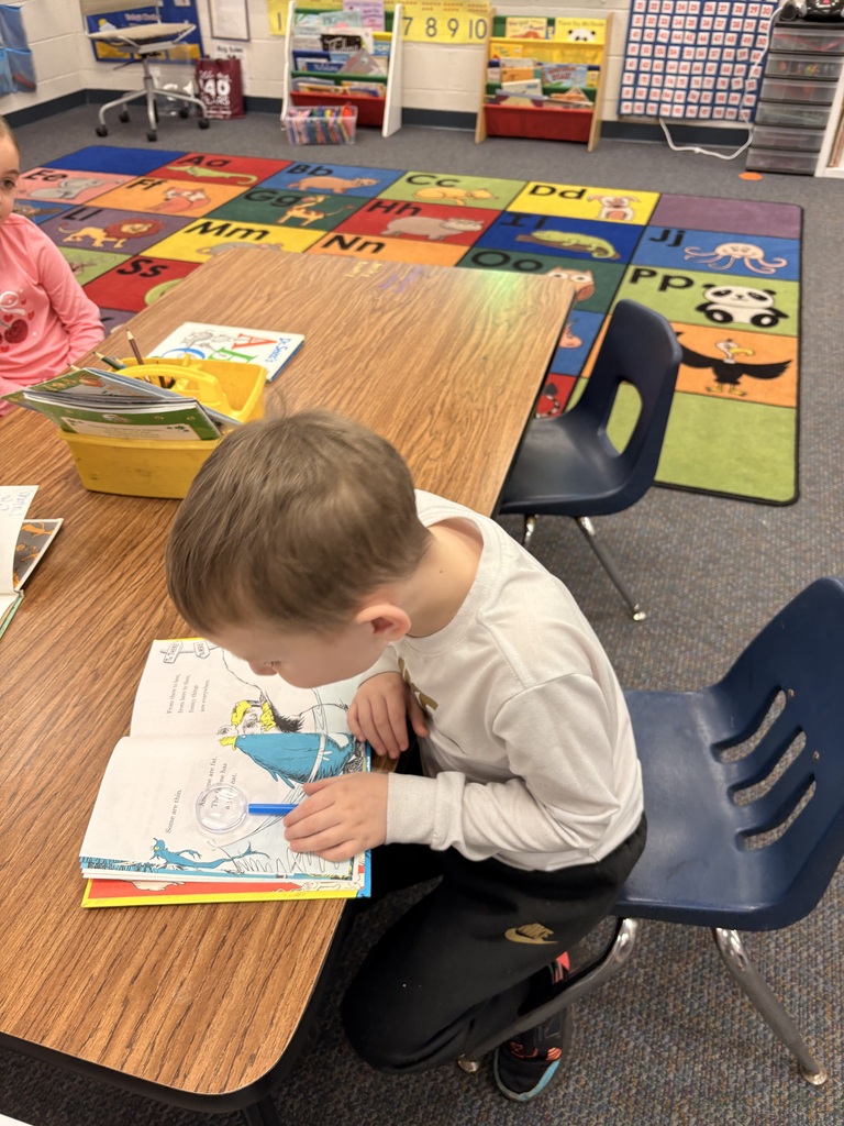 student reading with a magnifying glass