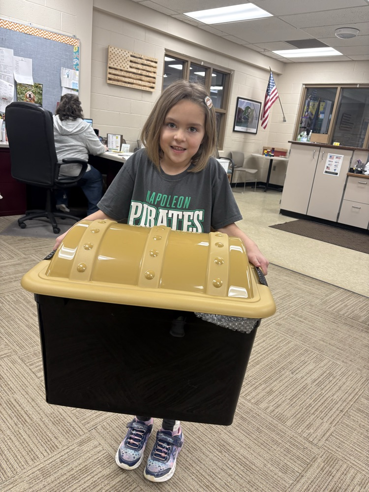student holding a large treasure chest