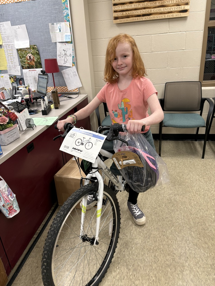 girl on bike in school office