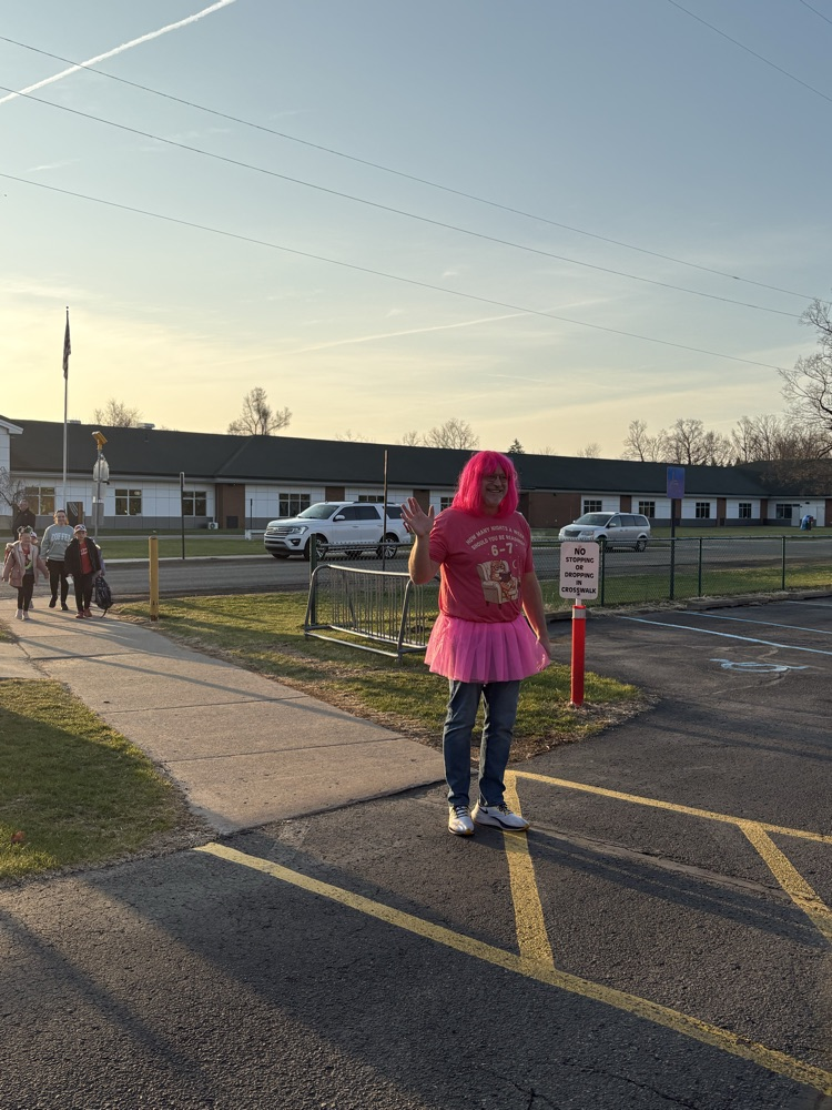 male principal dressed in pink wig and tutu at crosswalk