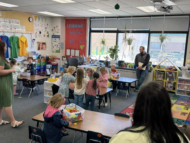 students with parents in a classroom 