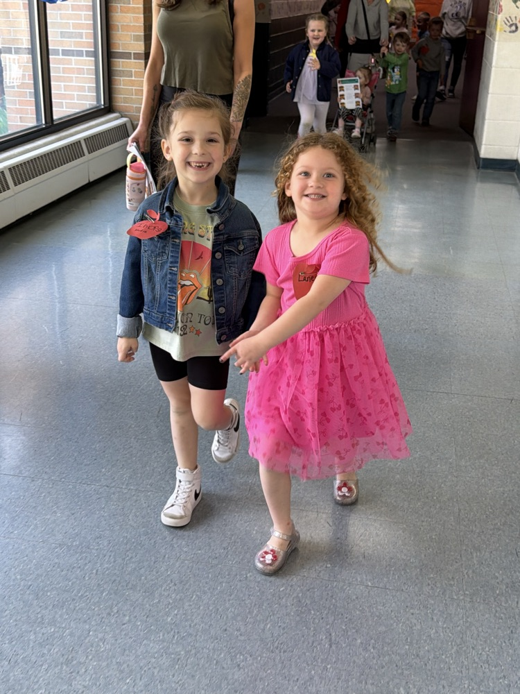 two girls walking in the hallway 