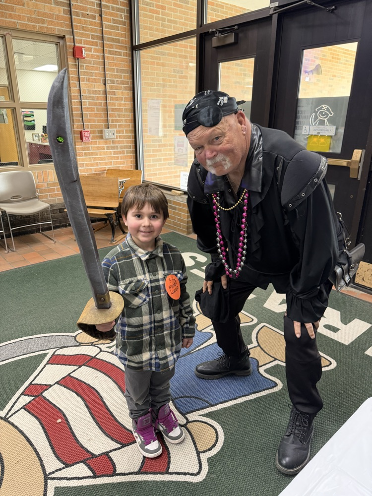 man in pirate costume standing with a boy