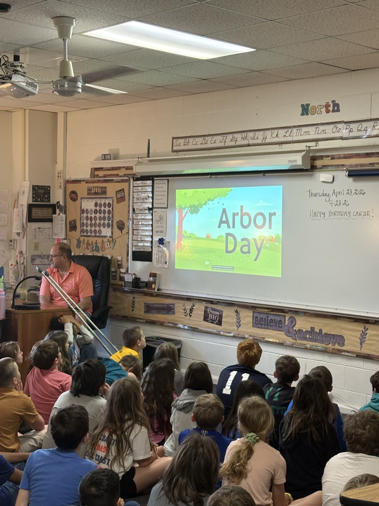 man and Arbor Day slide with kids on floor