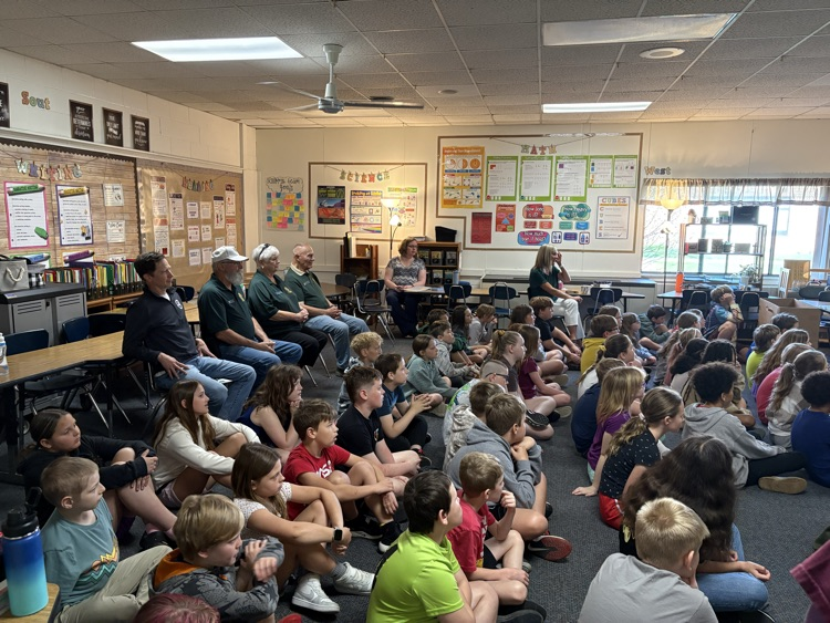 kids sitting on classroom floor
