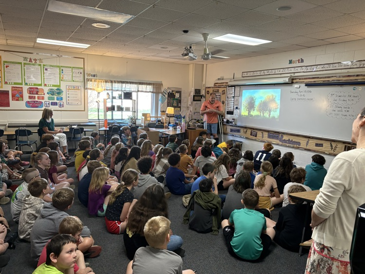 students on floor watching screen