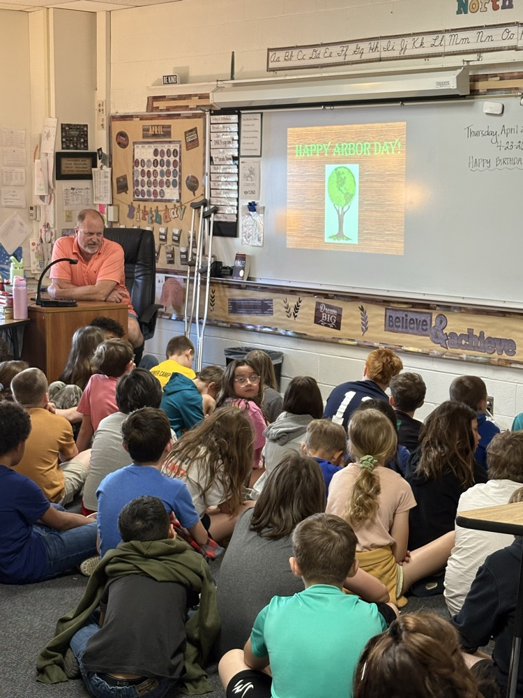 man presenting to students sitting on the floor