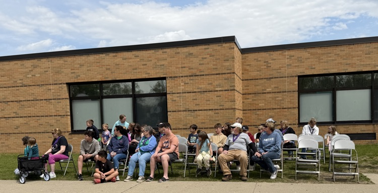 survivors sitting in chairs at the school 