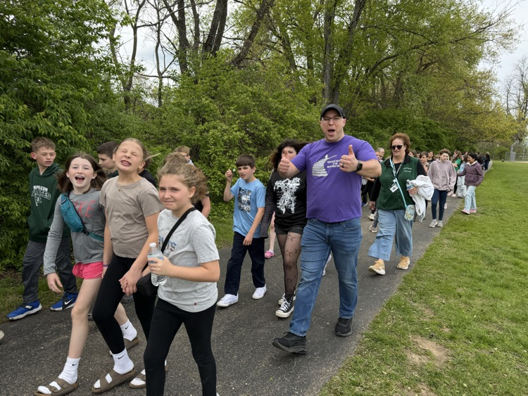 students and teacher walking on track 