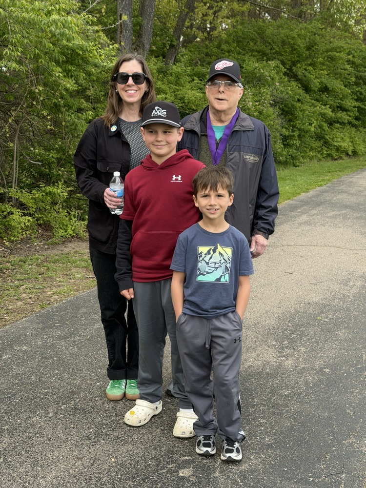 four people standing on track