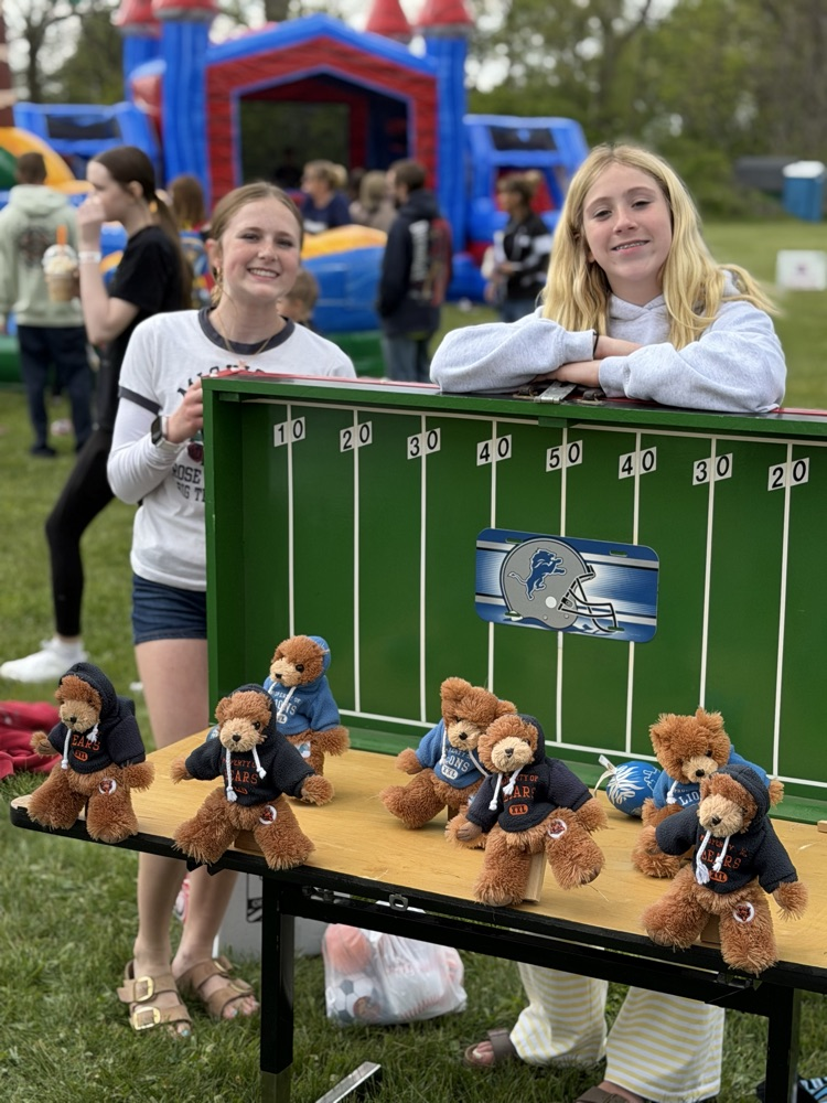 girls standing by football game