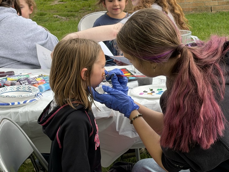 child getting her face painted 