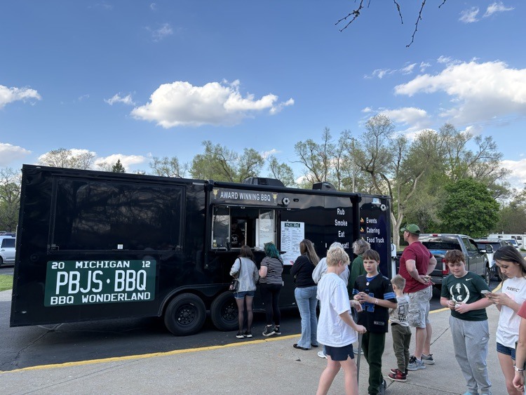 food truck with people standing in line