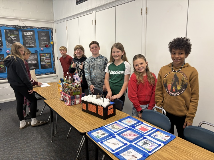 kids standing with projects