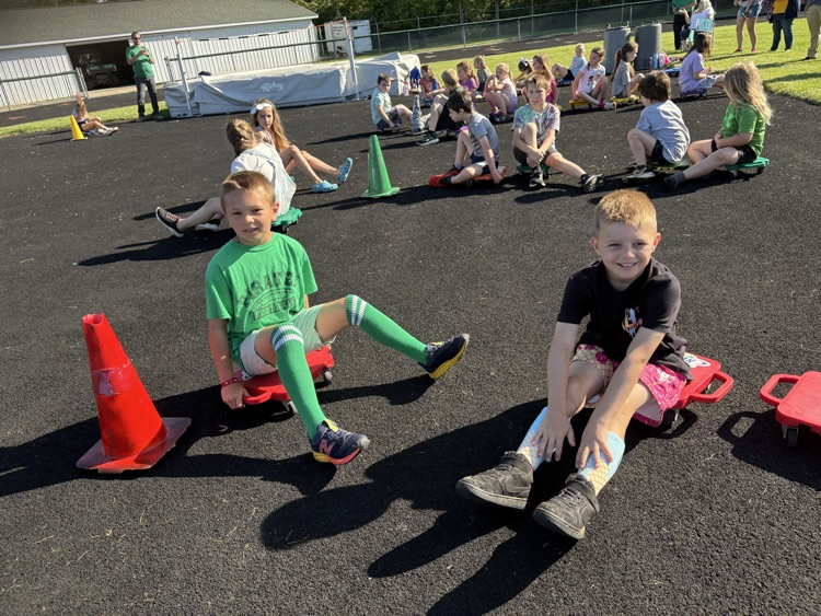 students on scooters at field day
