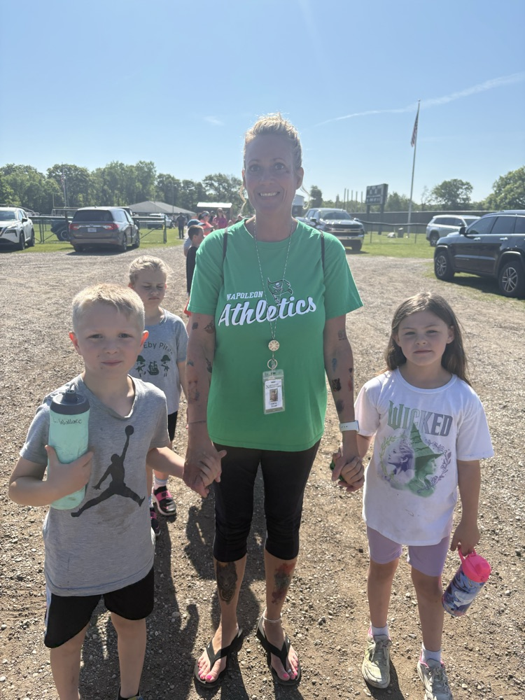 teacher standing with students at field day