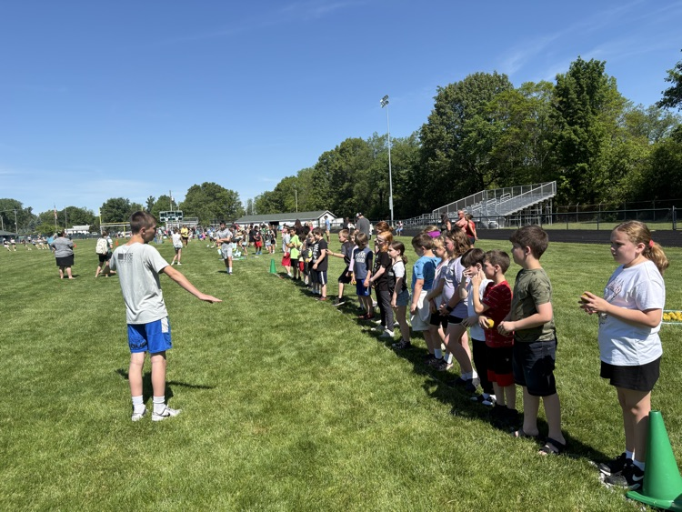 kids lined up to throw on football field