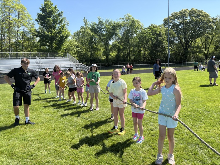kids playing tug o war on football field