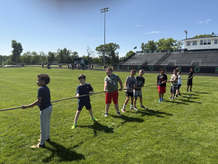 kids playing tug o war on football field