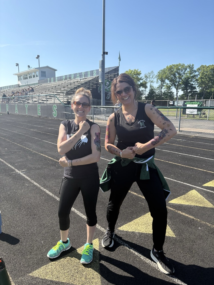 two ladies flexing tattoos
