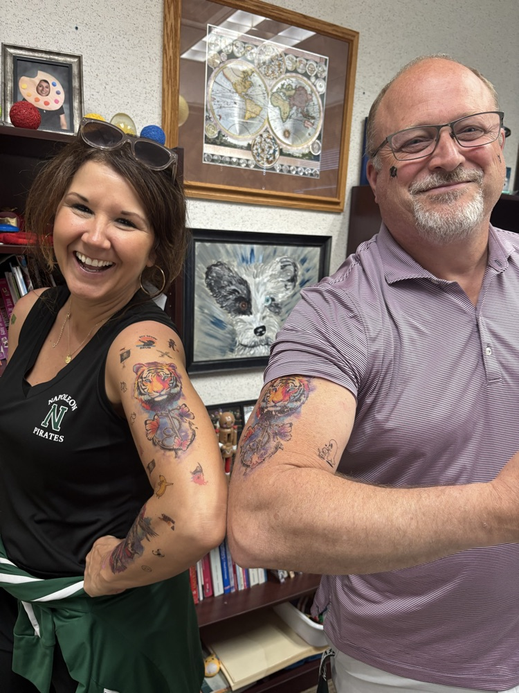 woman and man showing tattoos on arms