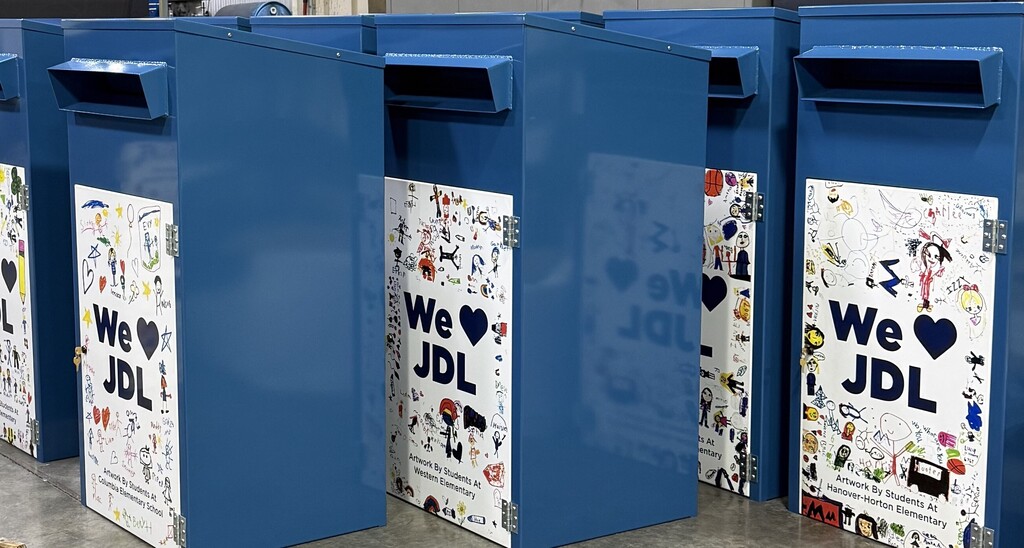 blue book drop off boxes with student drawings on the front