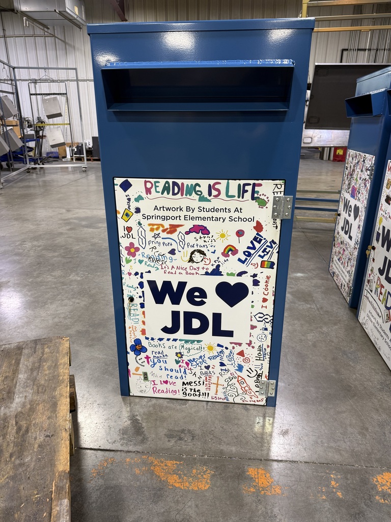 blue book drop off box with student drawings on it 