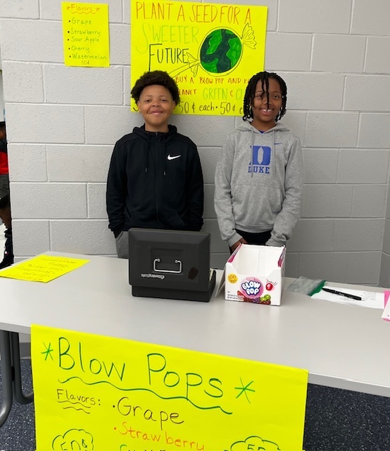 Two boys standing beside each other posing for a photo