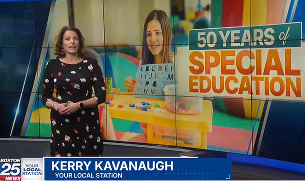Boston 25 news anchor Kerry Kavanaugh, stands in front of a screen that says "50 Years of Special Education"