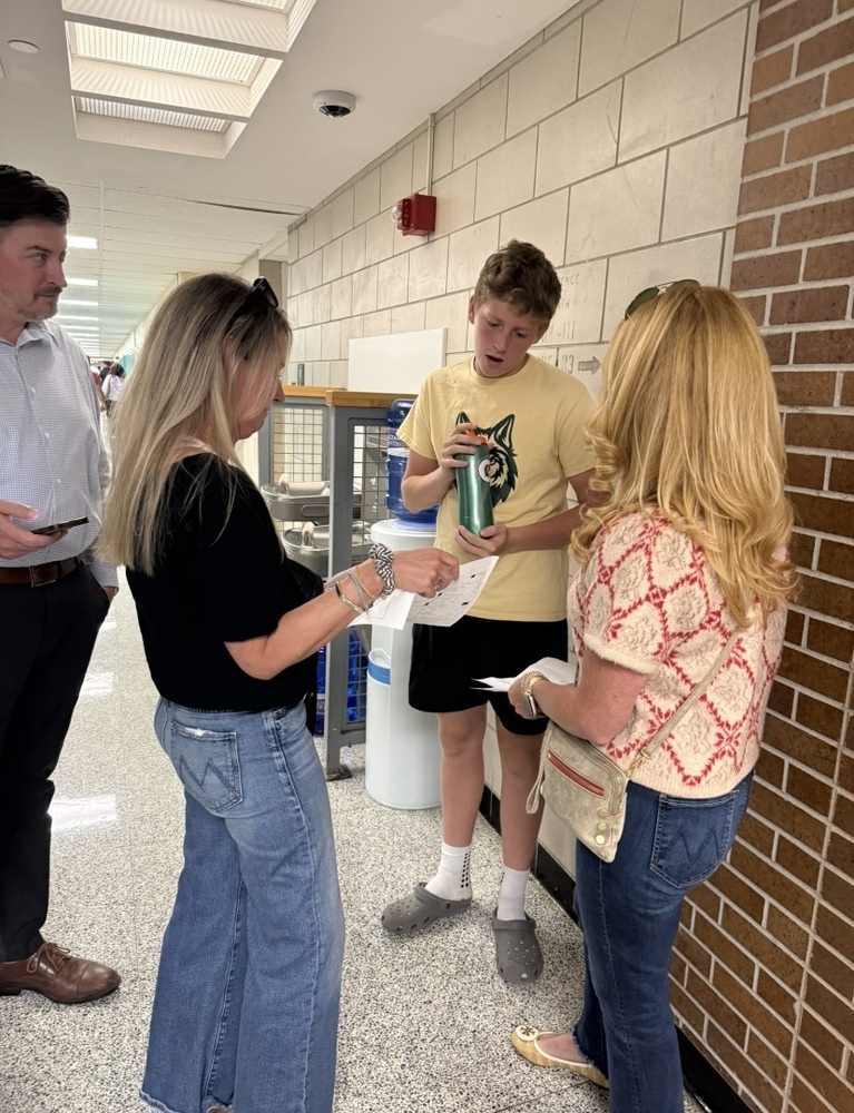 a student helps guide parents during the NRHS open house event.