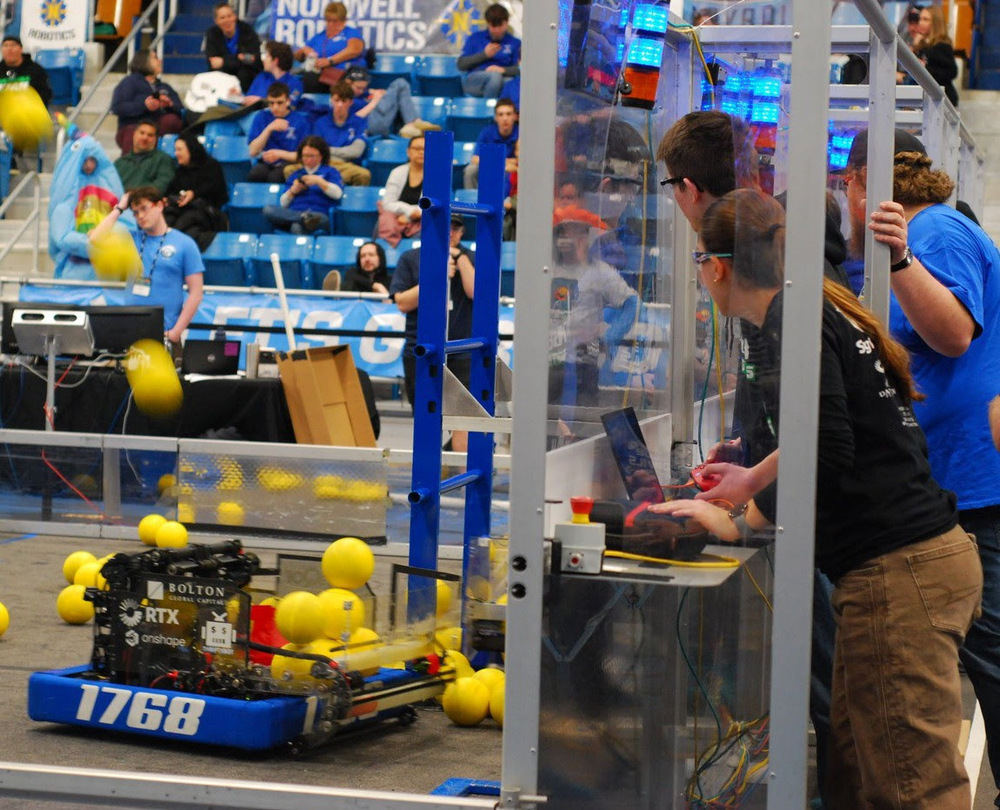 NRHS students operate their robot from the side of the arena.