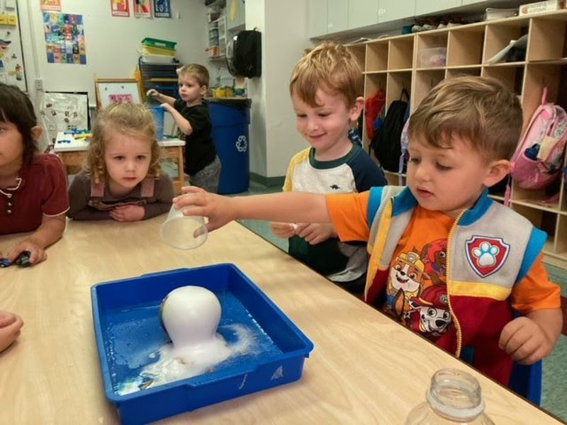 Pre-Kindergarten students doing a science project.