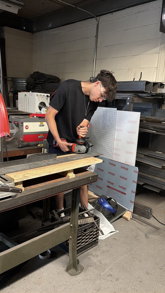 NRHS student using a metal cutting saw.