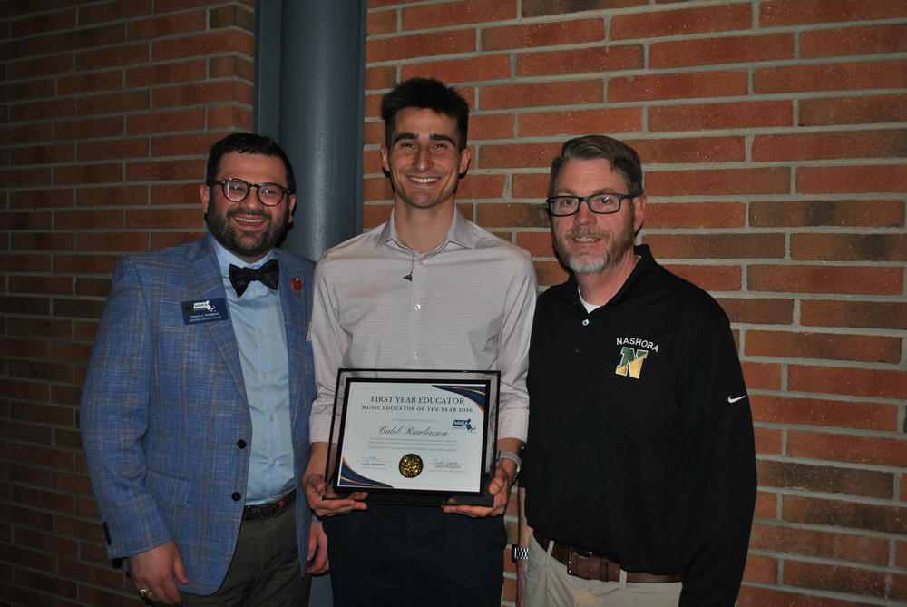 FSS music educator Caleb Rawlinson poses with his award and Principal Bates.